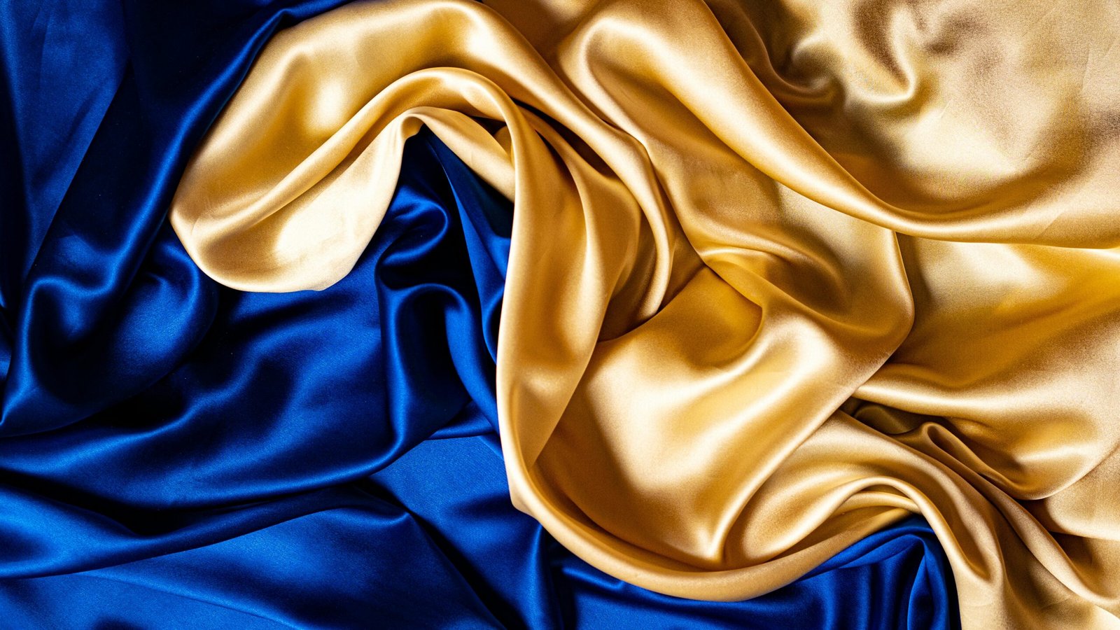 Blue and gold Thai silk fabric displaying rich multi-tonal color depth and natural sheen